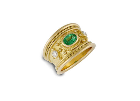 18ct yellow gold Templar ring featuring a 0.73ct oval Brazilian emerald, two diamonds, gold beads, twist-wire surround, and a linen-textured background.