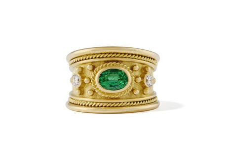 18ct yellow gold Templar ring featuring a 0.73ct oval Brazilian emerald, two diamonds, gold beads, twist-wire surround, and a linen-textured background.