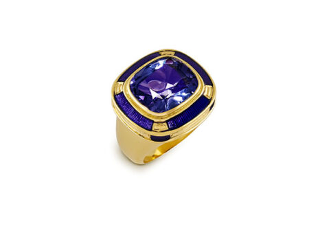Luxurious Charlemagne ring featuring an 11.67ct cushion-shaped faceted tanzanite at the center, surrounded by a gallery of matching purple enamel and intricately carved gold plinths. The design is completed with a polished bombé ring shank, blending classic elegance with modern craftsmanship
