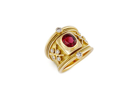 18ct yellow gold Templar ring with a 1.95ct red spinel, diamond accents, gold bead detailing, and a linen-textured background.
