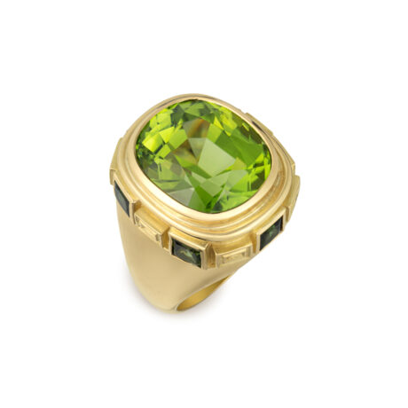 18ct yellow gold Charlemagne ring featuring a cushion-shaped faceted peridot and princess-cut green tourmalines with carved gold plinths by Elizabeth Gage
