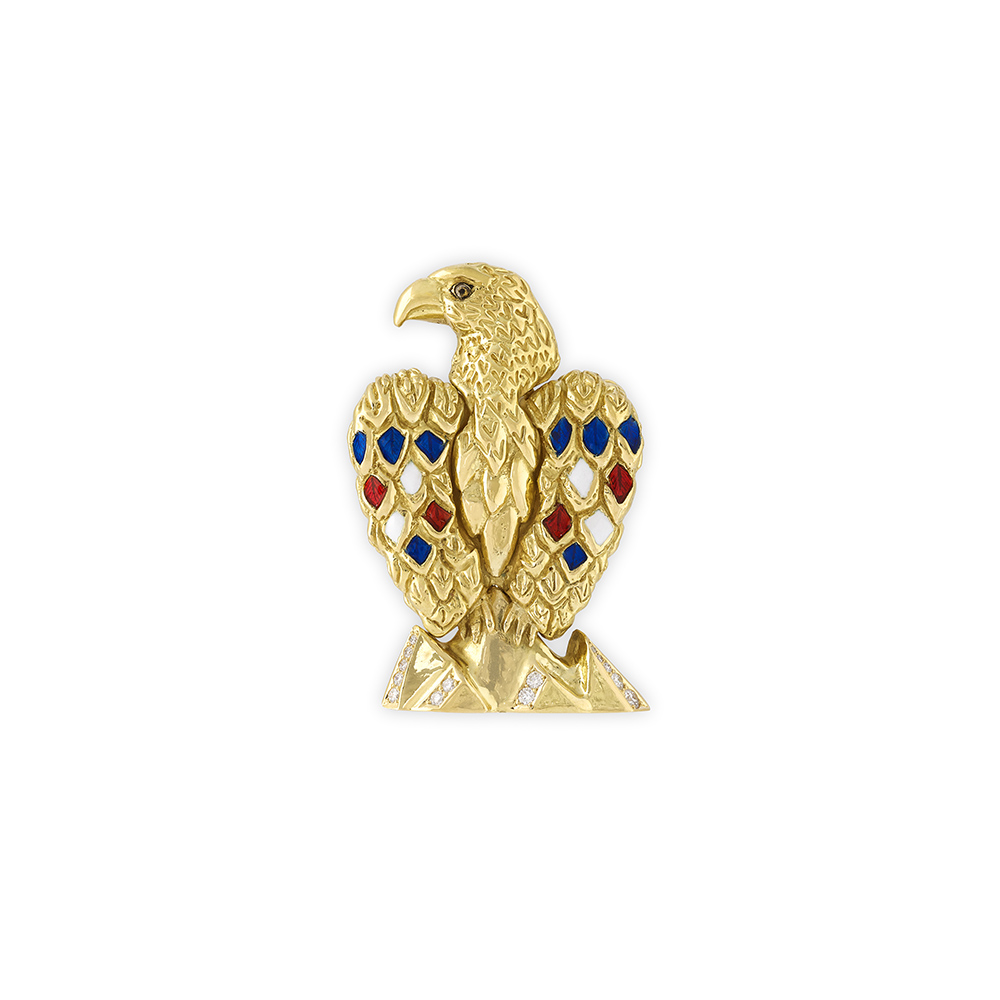 18ct yellow gold bald eagle pin with red, white and blue enamel feathers, rock crystal eye, and diamond-set mountain peaks.